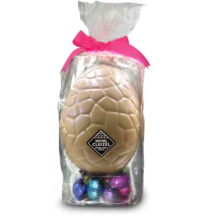 Giant white chocolate Easter egg with mini eggs colorfully wrapped filled chocolate eggs, 63% dark & 39% milk, filled with ganache, praliné, & gianduja, a smooth and creamy mix of dark chocolate and pure hazelnut paste.