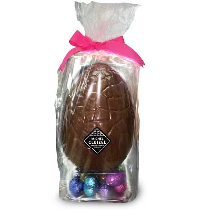 Giant milk chocolate Easter egg with mini eggs filled with ganache, praliné, & gianduja, a smooth and creamy mix of dark chocolate and pure hazelnut paste.