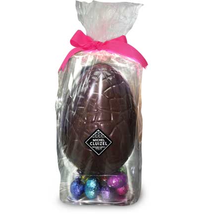 Giant dark chocolate Easter egg with mini eggs filled with ganache, praliné, & gianduja, a smooth and creamy mix of dark chocolate and pure hazelnut paste.